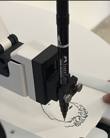 Close-up of the real DexArm pen holder drawing a portrait